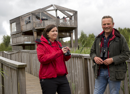 Janine and man outside obs with binoculars